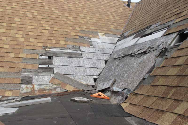 Detroit Metro Home with a roof missing shingles due to poor installation