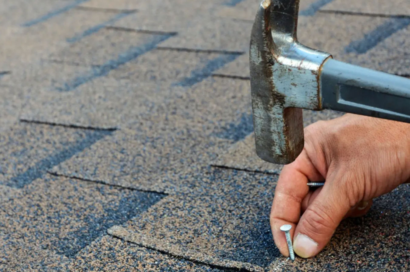 Homeowner in Detroit, Michigan fixing and repairing his roof