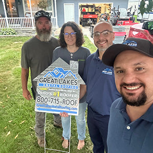 Happy customer with Great Lakes Home Remodeling sign