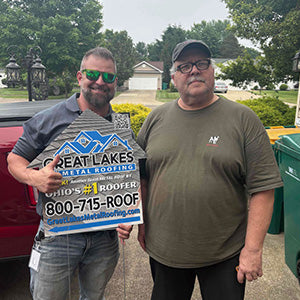 Happy customer with Great Lakes Home Remodeling sign