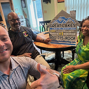 Happy customer with Great Lakes Home Remodeling sign