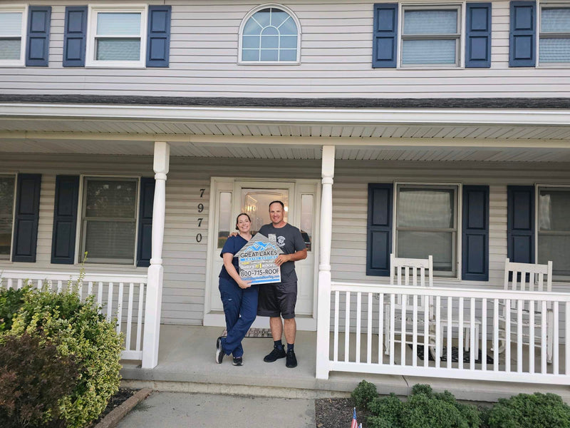 Happy customer with Great Lakes Home Remodeling sign