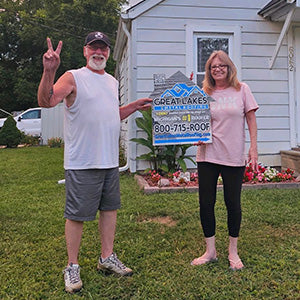 Happy customer with Great Lakes Home Remodeling sign