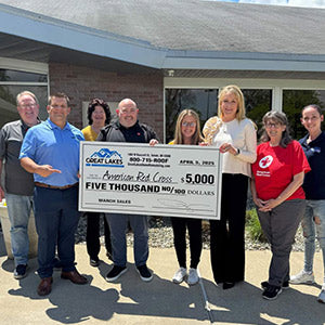 Great Lakes Home Remodeling handing a check for a charity association