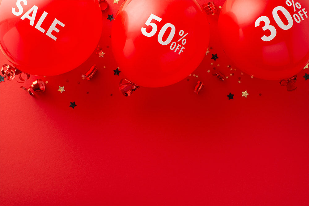 Red balloons with sale text on a red background