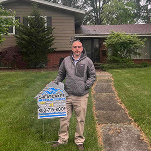 Happy customer with Great Lakes Home Remodeling sign