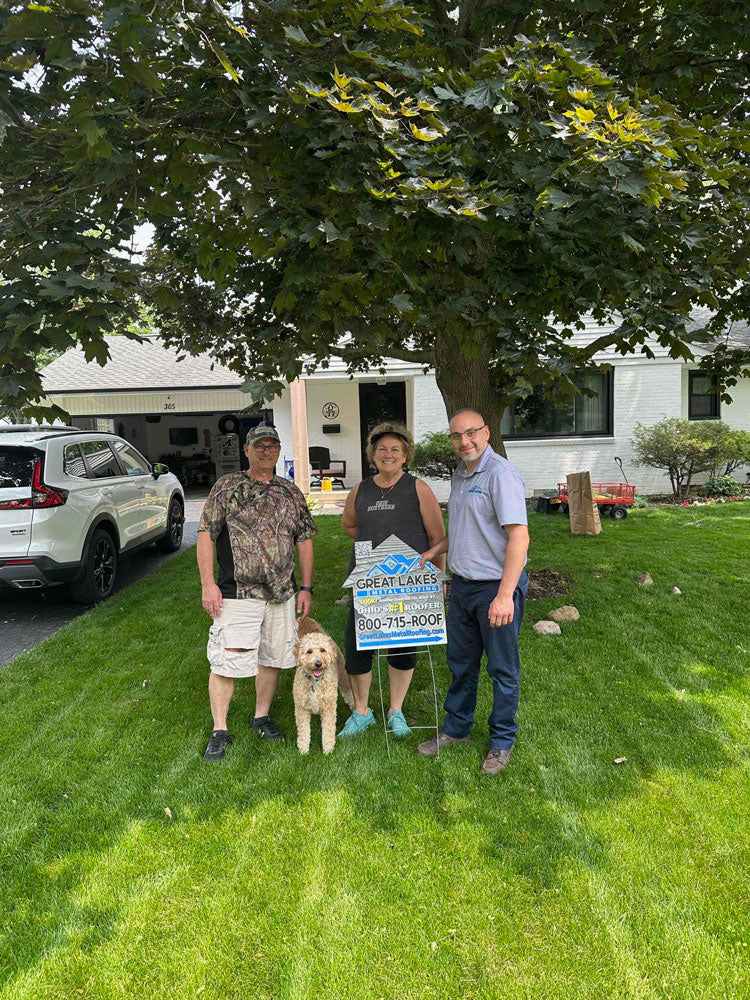 Happy customer with Great Lakes Home Remodeling sign