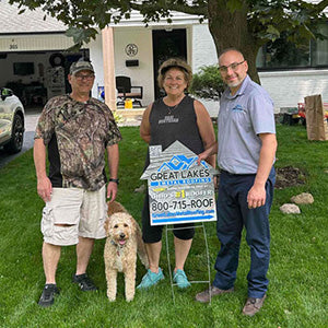 Happy customer with Great Lakes Home Remodeling sign