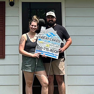 Happy customer with Great Lakes Home Remodeling sign